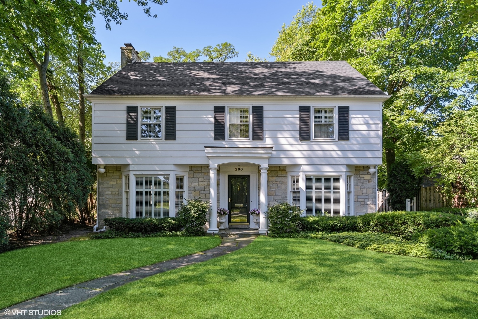 200 Sheridan Road Winnetka, IL 60093 - Photo 1 of 28 a front view of a house with a garden