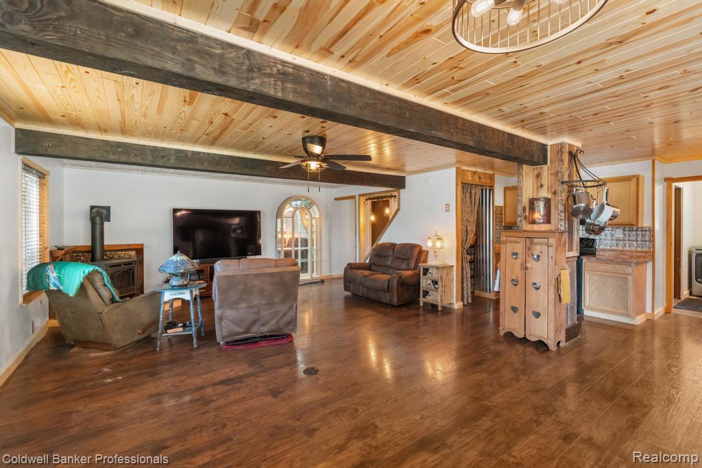 6389 Postlewait Road Mancelona, MI 49659 - Photo 27 of 50 Wood-finish flooring with exposed wood beams and wood plank ceiling