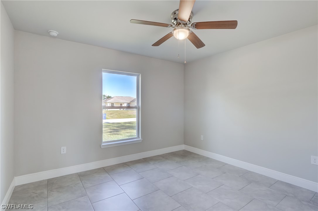 3215 46th Street West Lehigh Acres, FL 33971 - Photo 20 of 50 an empty room with a window and a fan