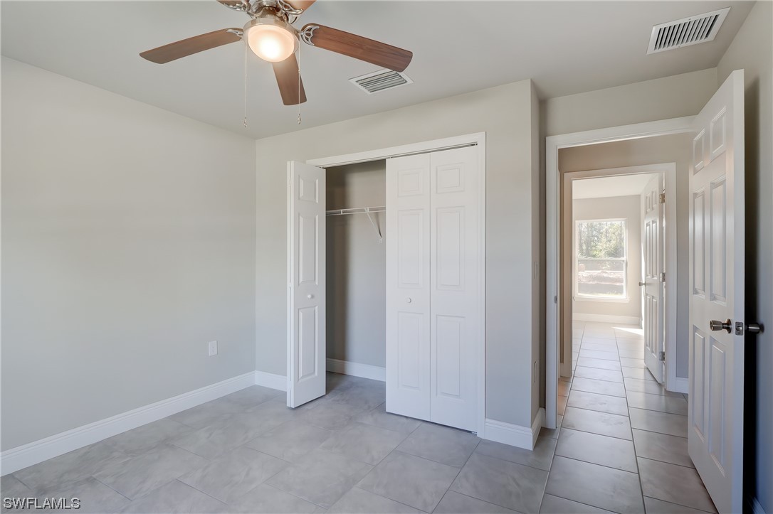3215 46th Street West Lehigh Acres, FL 33971 - Photo 21 of 50 a view of an entryway and a chandelier fan in a room