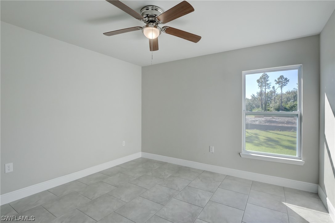 3215 46th Street West Lehigh Acres, FL 33971 - Photo 24 of 50 an empty room with windows and fan
