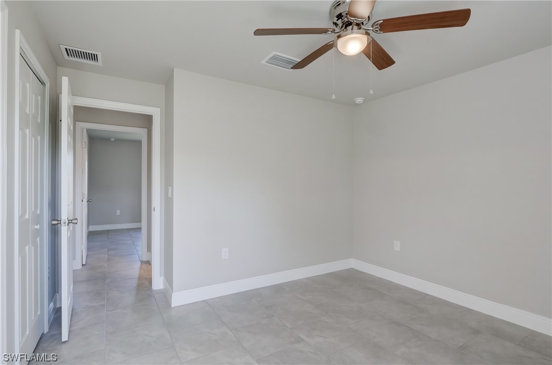 3215 46th Street West Lehigh Acres, FL 33971 - Photo 25 of 50 an empty room and chandelier fan