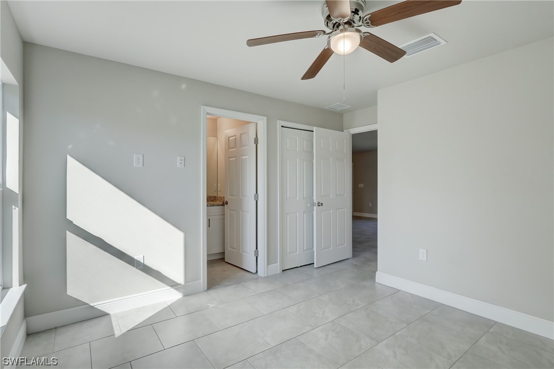3215 46th Street West Lehigh Acres, FL 33971 - Photo 26 of 50 a view of an empty room and chandelier fan