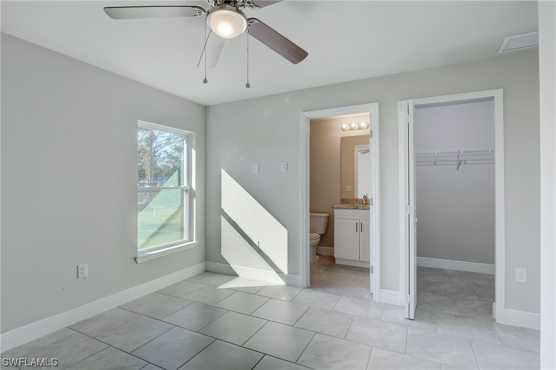 3215 46th Street West Lehigh Acres, FL 33971 - Photo 27 of 50 wooden floor in an empty room with a window