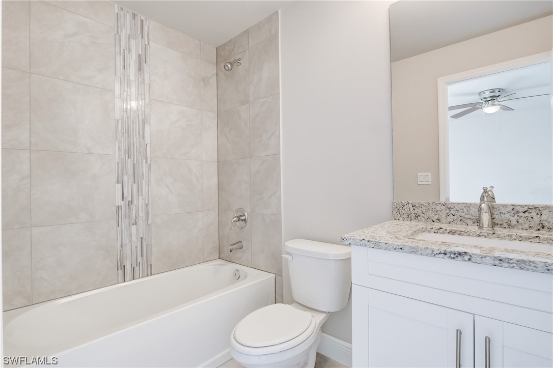 3215 46th Street West Lehigh Acres, FL 33971 - Photo 29 of 50 a bathroom with a granite countertop sink toilet and shower