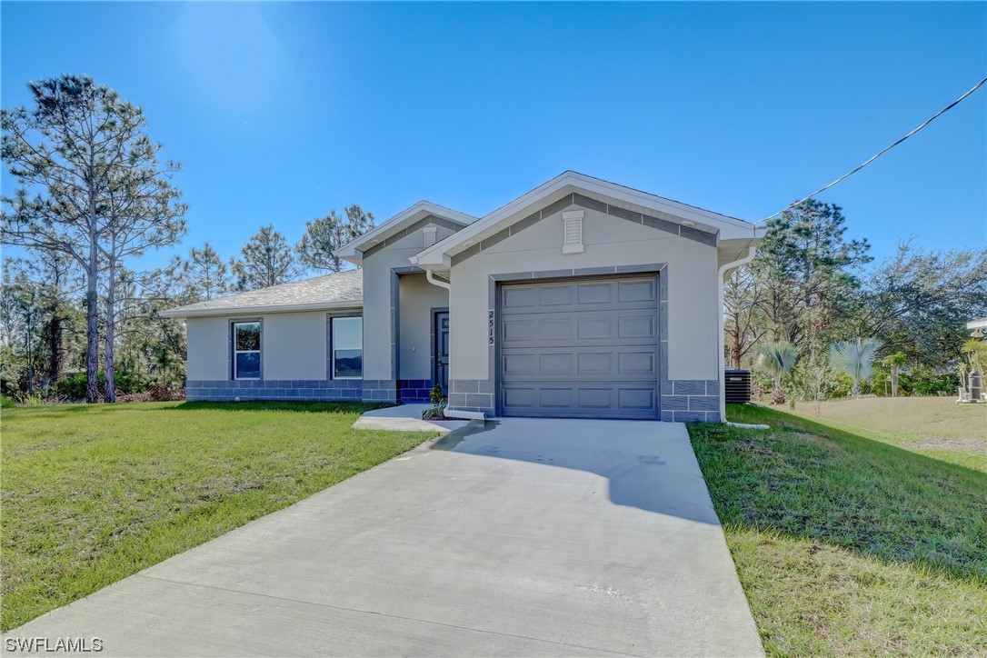 3215 46th Street West Lehigh Acres, FL 33971 - Photo 3 of 50 a front view of a house with garden