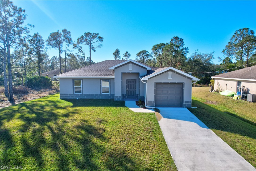 3215 46th Street West Lehigh Acres, FL 33971 - Photo 33 of 50 a front view of a house with garden