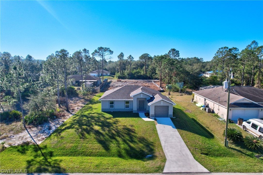 3215 46th Street West Lehigh Acres, FL 33971 - Photo 35 of 50 a aerial view of a house with a big yard