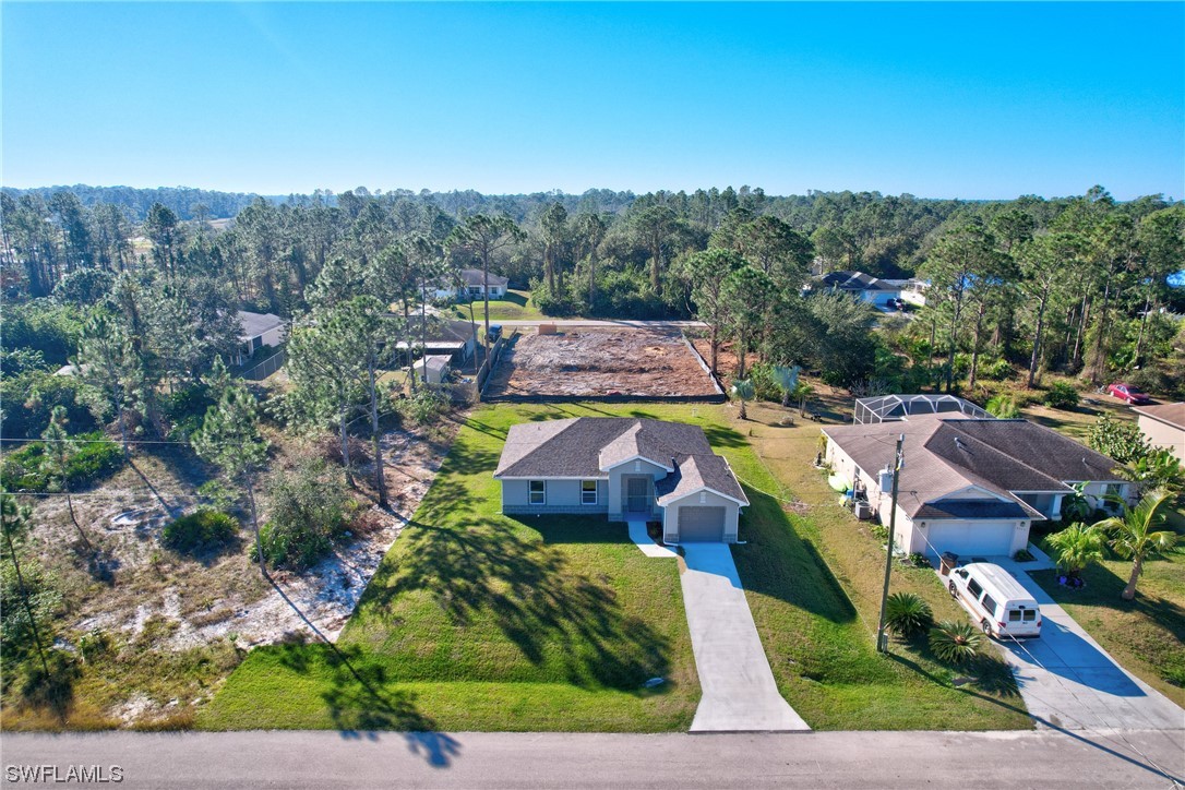 3215 46th Street West Lehigh Acres, FL 33971 - Photo 36 of 50 an aerial view of a house with a garden