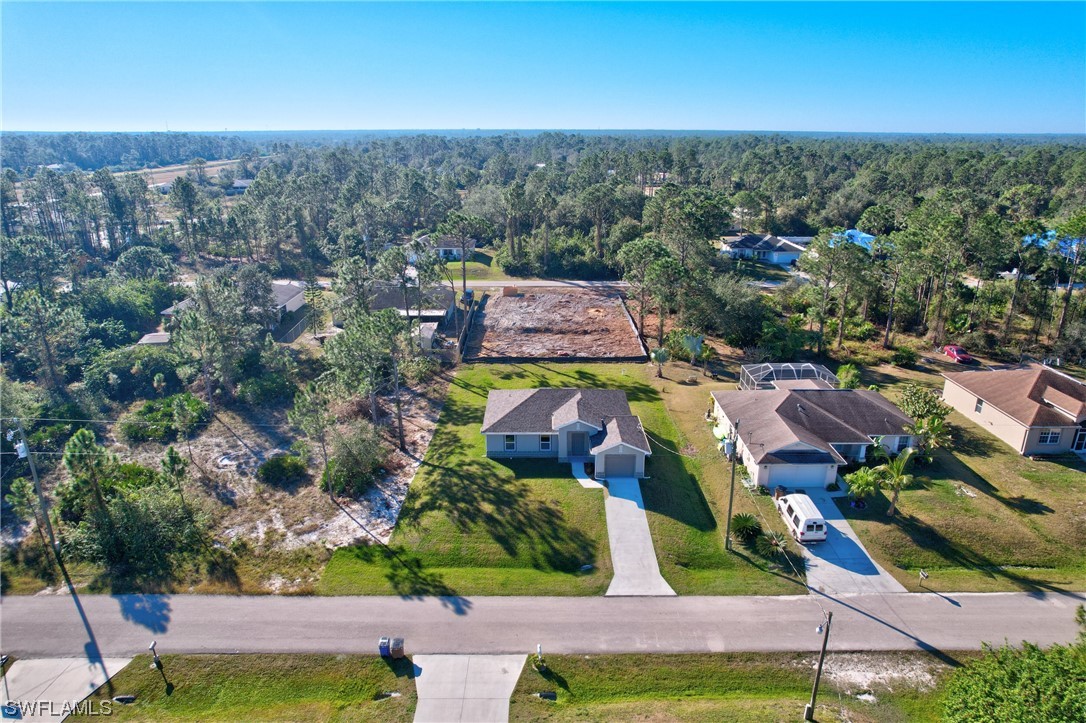 3215 46th Street West Lehigh Acres, FL 33971 - Photo 37 of 50 an aerial view of residential houses with outdoor space and swimming pool