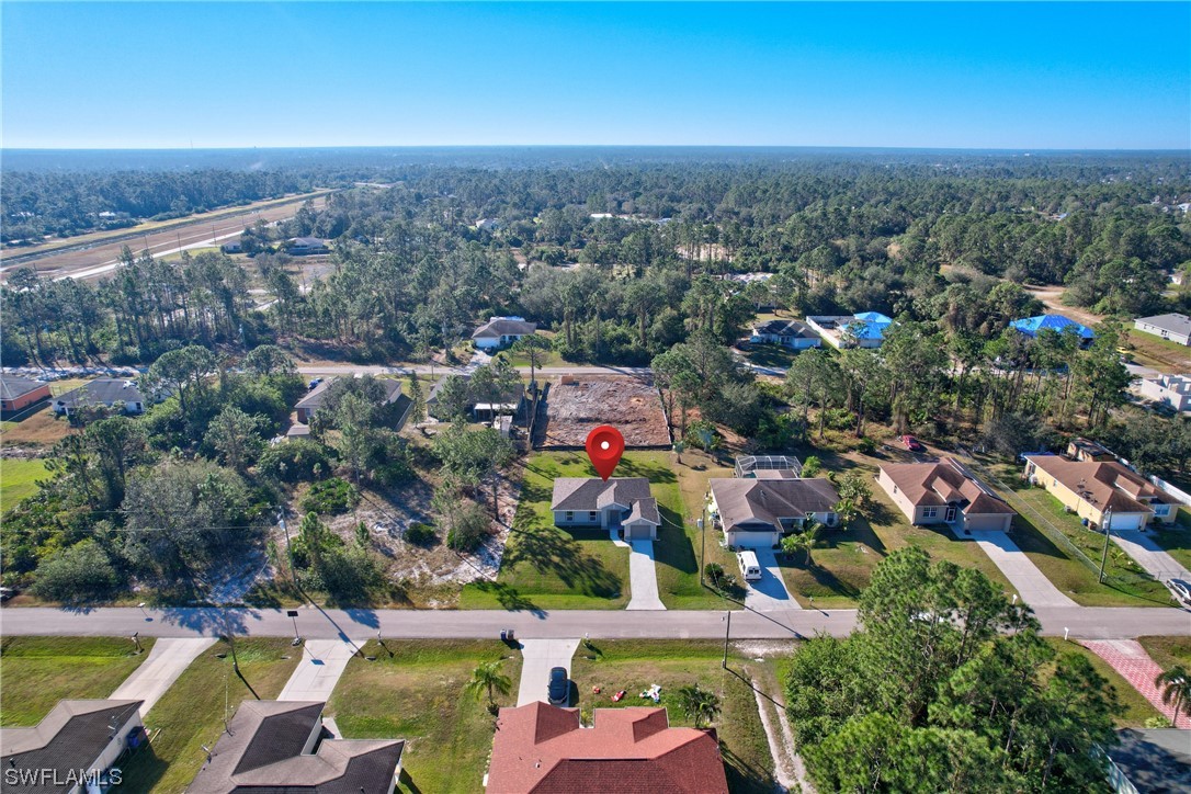 3215 46th Street West Lehigh Acres, FL 33971 - Photo 39 of 50 an aerial view of residential houses with outdoor space and swimming pool