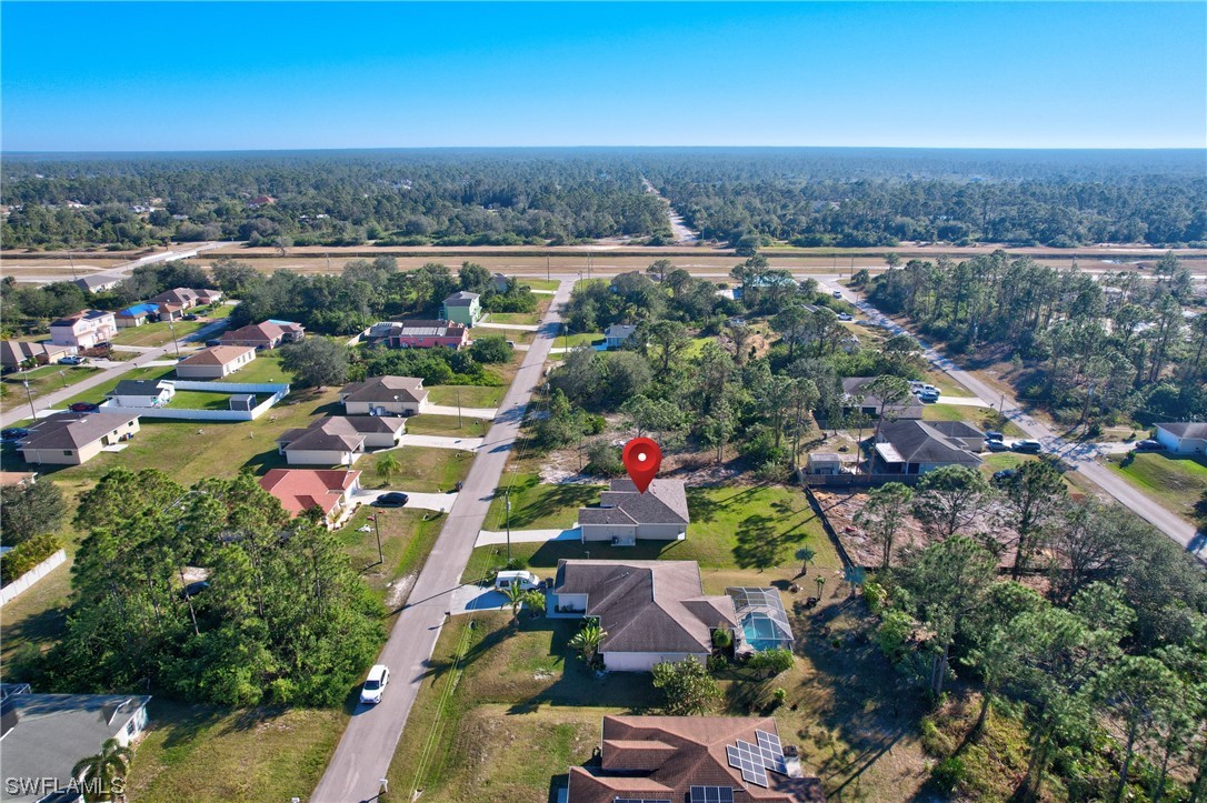 3215 46th Street West Lehigh Acres, FL 33971 - Photo 41 of 50 an aerial view of residential houses with outdoor space and swimming pool