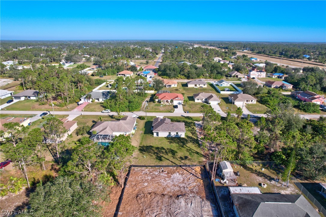 3215 46th Street West Lehigh Acres, FL 33971 - Photo 48 of 50 an aerial view of residential houses with outdoor space and trees