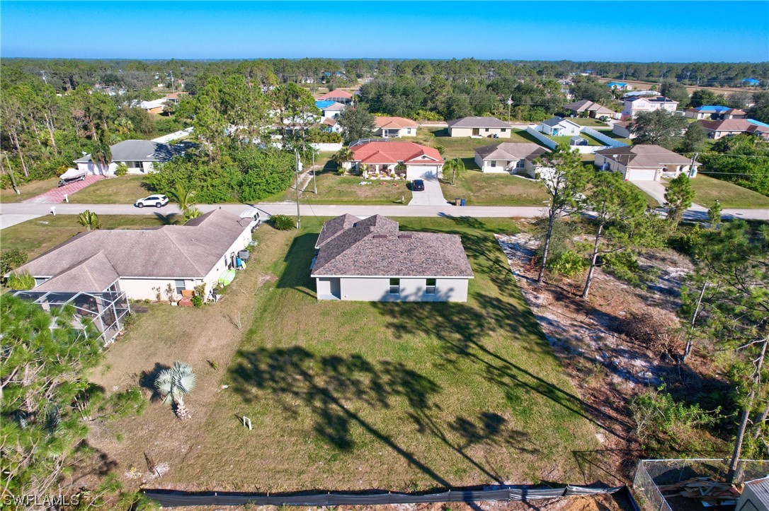 3215 46th Street West Lehigh Acres, FL 33971 - Photo 50 of 50 an aerial view of residential houses with outdoor space