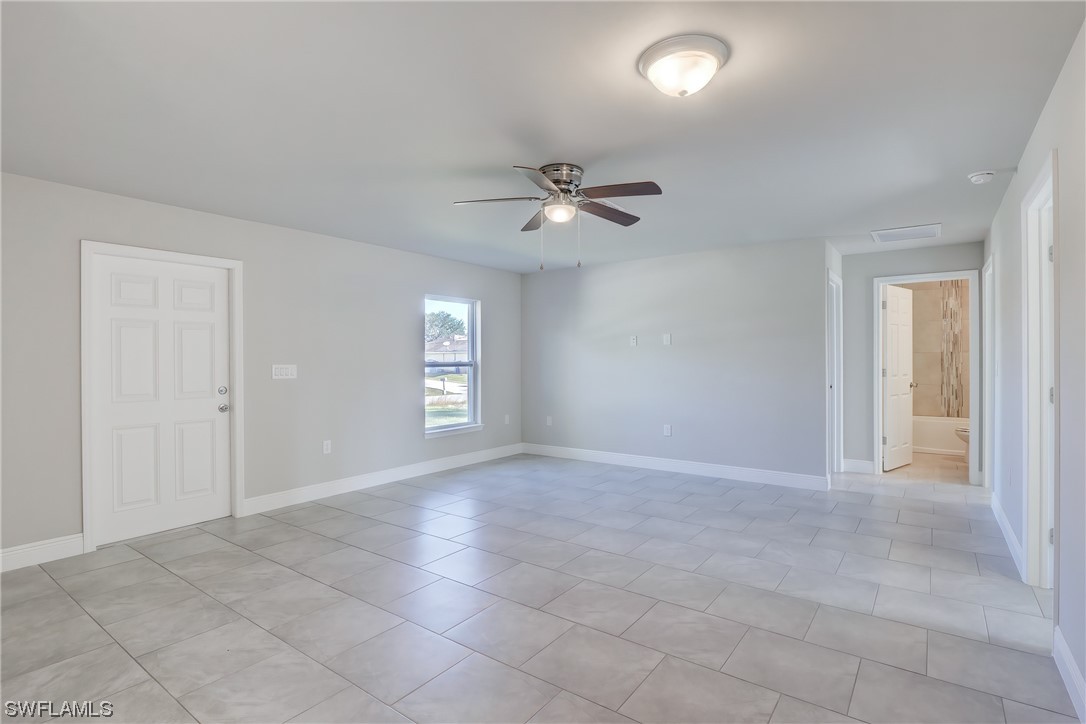 3215 46th Street West Lehigh Acres, FL 33971 - Photo 7 of 50 an empty room with fan and windows
