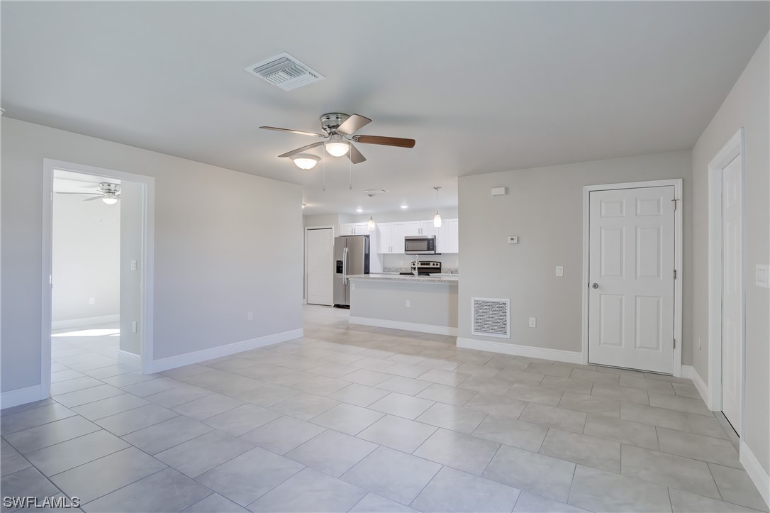 3215 46th Street West Lehigh Acres, FL 33971 - Photo 9 of 50 a view of a livingroom with a kitchen