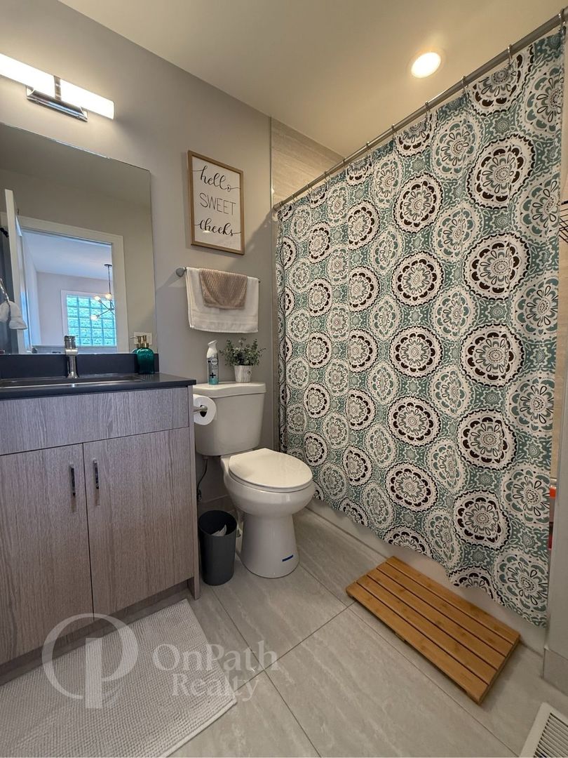 6834 West 65th Street, Unit 1 Chicago, IL 60638 - Photo 15 of 20 a bathroom with a toilet and a sink