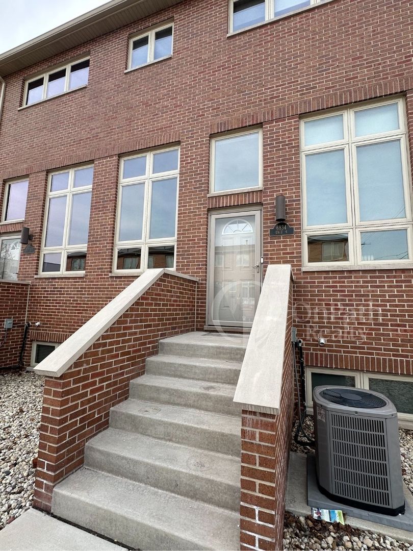 6834 West 65th Street, Unit 1 Chicago, IL 60638 - Photo 2 of 20 a view of a brick house with large windows