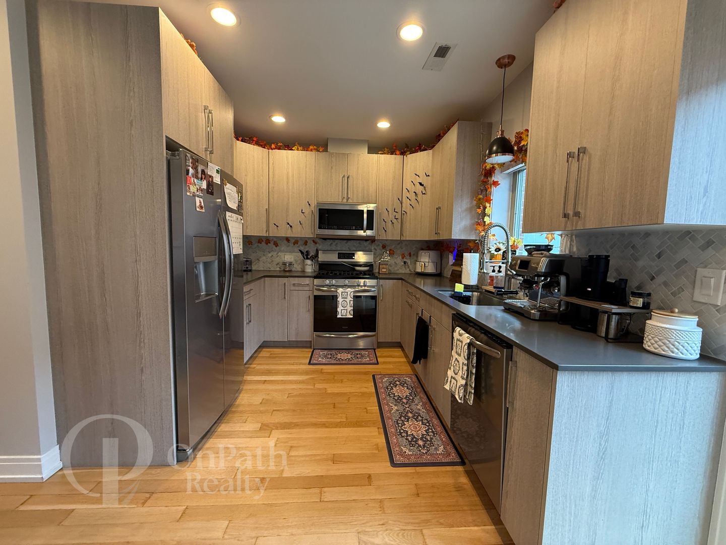 6834 West 65th Street, Unit 1 Chicago, IL 60638 - Photo 5 of 20 a kitchen with stainless steel appliances granite countertop a refrigerator a stove and a sink