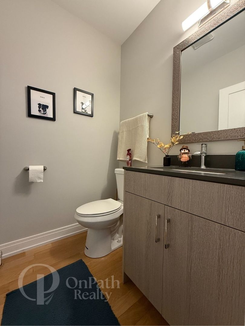 6834 West 65th Street, Unit 1 Chicago, IL 60638 - Photo 9 of 20 a bathroom with a sink toilet and a mirror