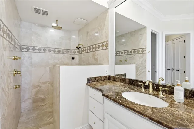 a spacious bedroom with a bed and a chandelier