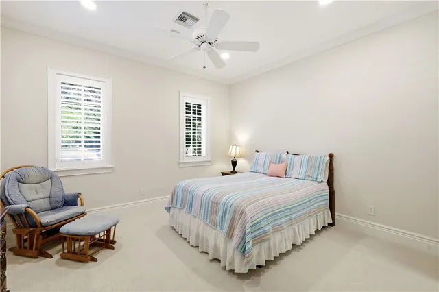 a spacious bedroom with a bed and a chandelier