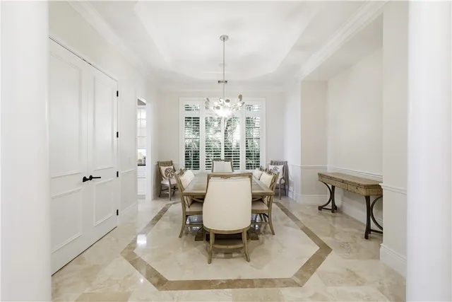 a very nice looking room with a large window and chandelier