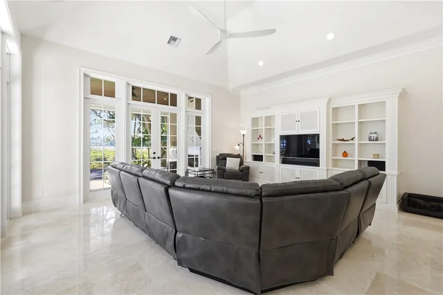 a kitchen with stainless steel appliances granite countertop white cabinets and refrigerator