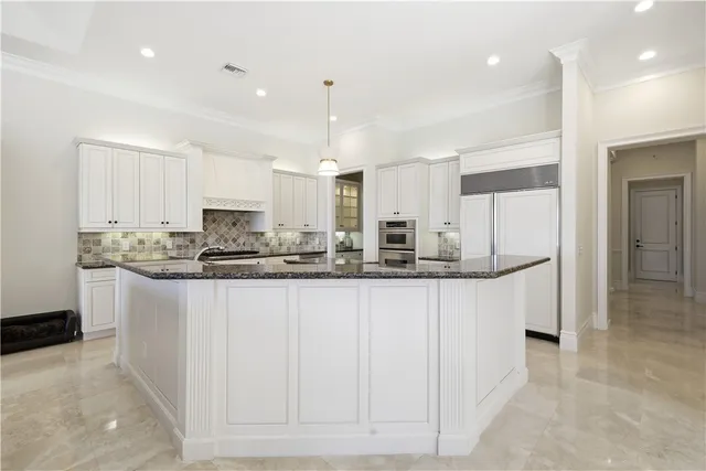 a stove top oven sitting inside of a kitchen
