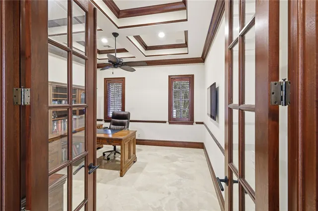 a bedroom with a bed and a large window