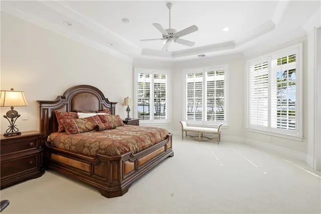 a living room with furniture a flat screen tv and a large window