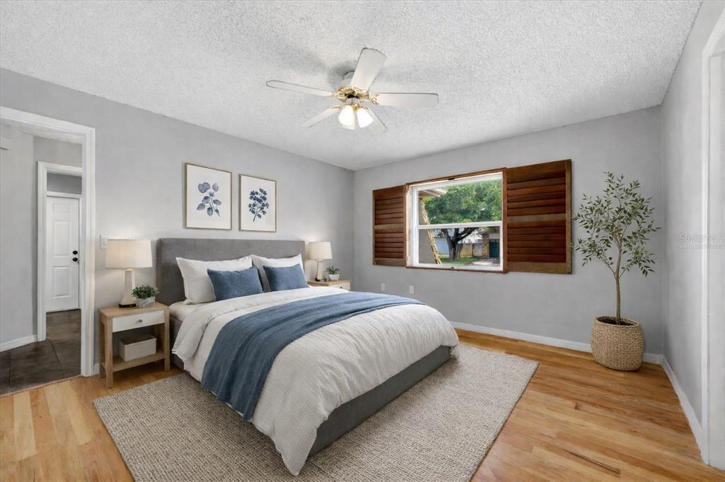 12836 Pineway Drive Largo, FL 33773 - Photo 11 of 28 a bedroom with a large bed and a window