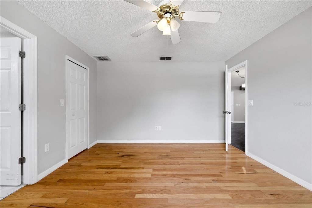 12836 Pineway Drive Largo, FL 33773 - Photo 14 of 28 a view of empty room with wooden floor