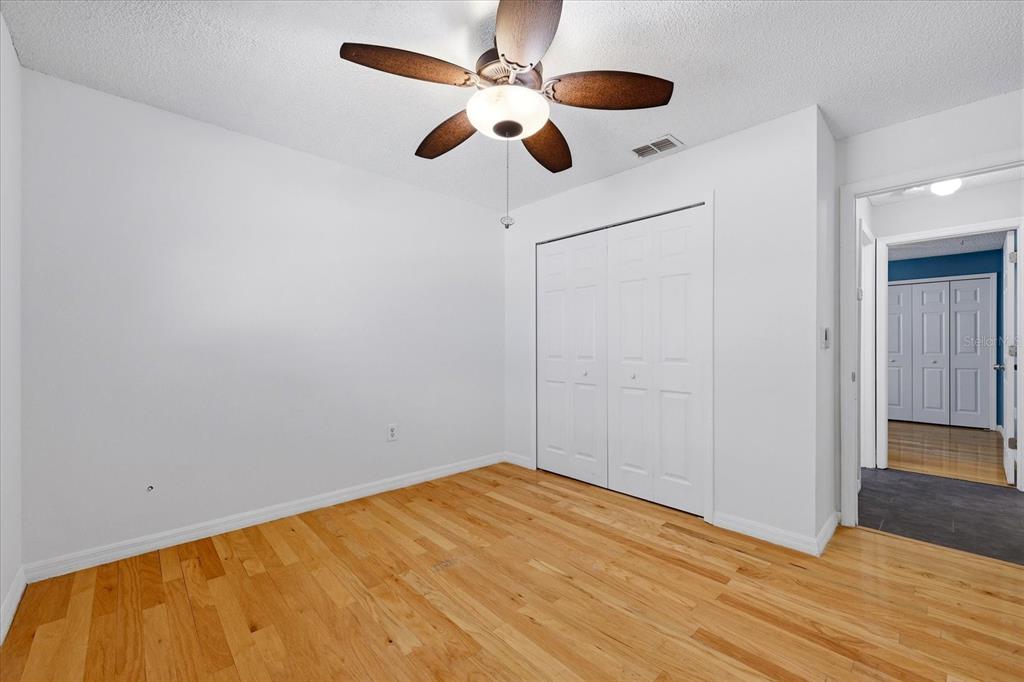 12836 Pineway Drive Largo, FL 33773 - Photo 17 of 28 a view of an empty room with wooden floor