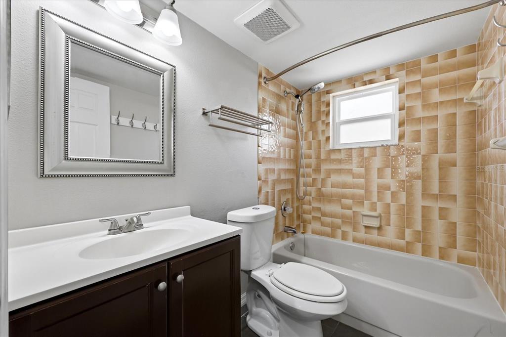 12836 Pineway Drive Largo, FL 33773 - Photo 18 of 28 a bathroom with a sink a toilet and shower
