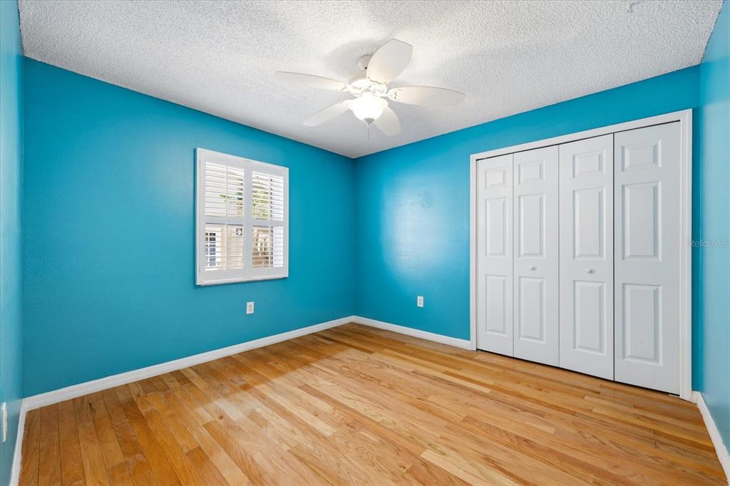 12836 Pineway Drive Largo, FL 33773 - Photo 19 of 28 an empty room with a window and a ceiling fan