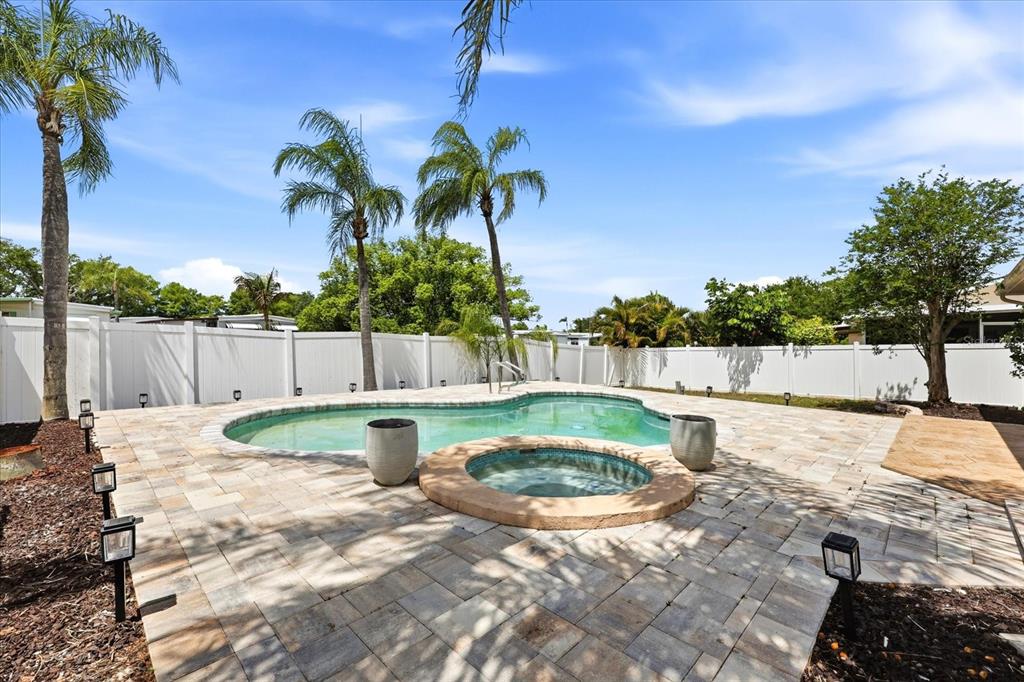12836 Pineway Drive Largo, FL 33773 - Photo 23 of 28 a view of swimming pool with a patio