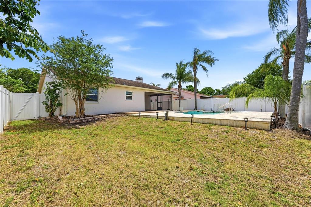 12836 Pineway Drive Largo, FL 33773 - Photo 25 of 28 a view of a back yard of the house