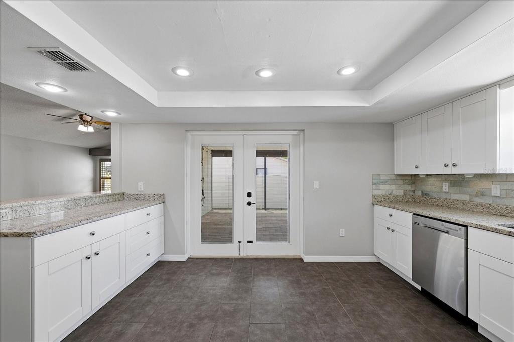 12836 Pineway Drive Largo, FL 33773 - Photo 7 of 28 a bathroom with a granite countertop sink and a large mirror