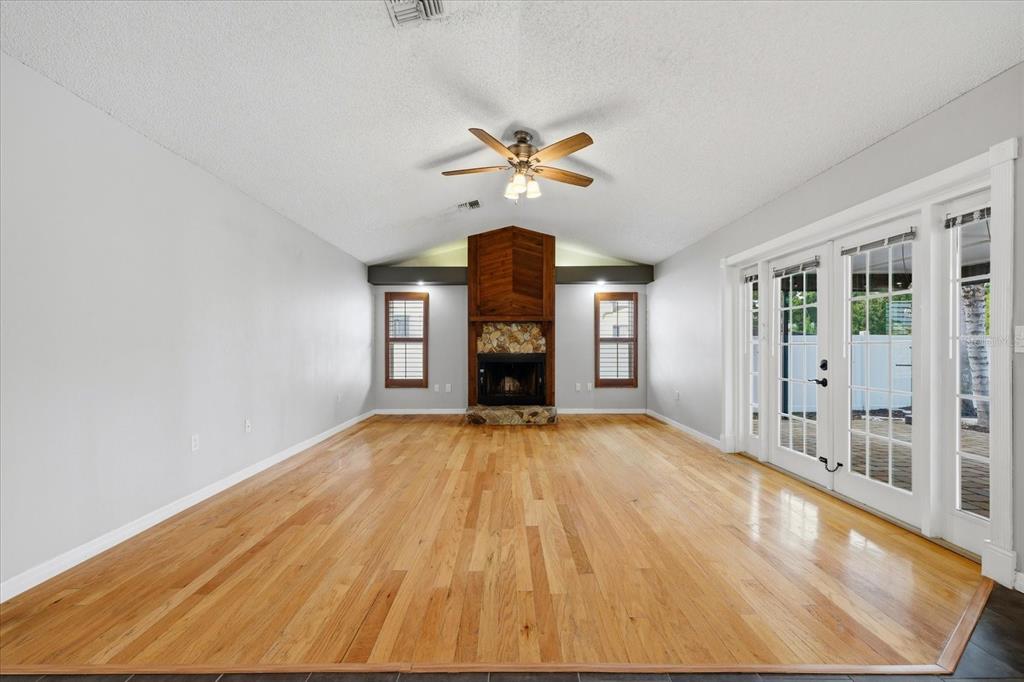 12836 Pineway Drive Largo, FL 33773 - Photo 10 of 28 a view of empty room with wooden floor and fan