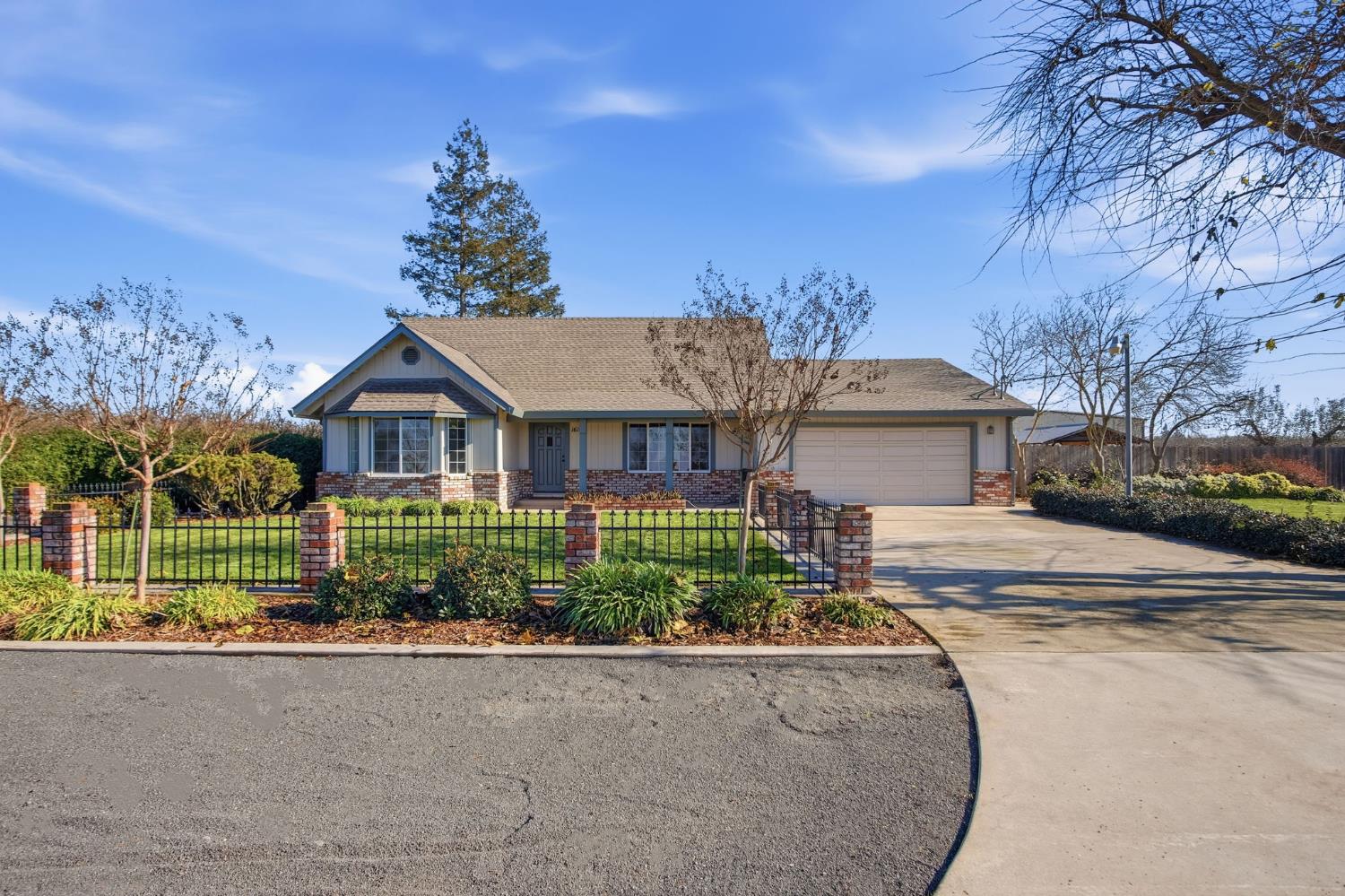 16166 Lawrence Road Escalon, CA 95320 - Photo 2 of 56 a front view of a house with garden