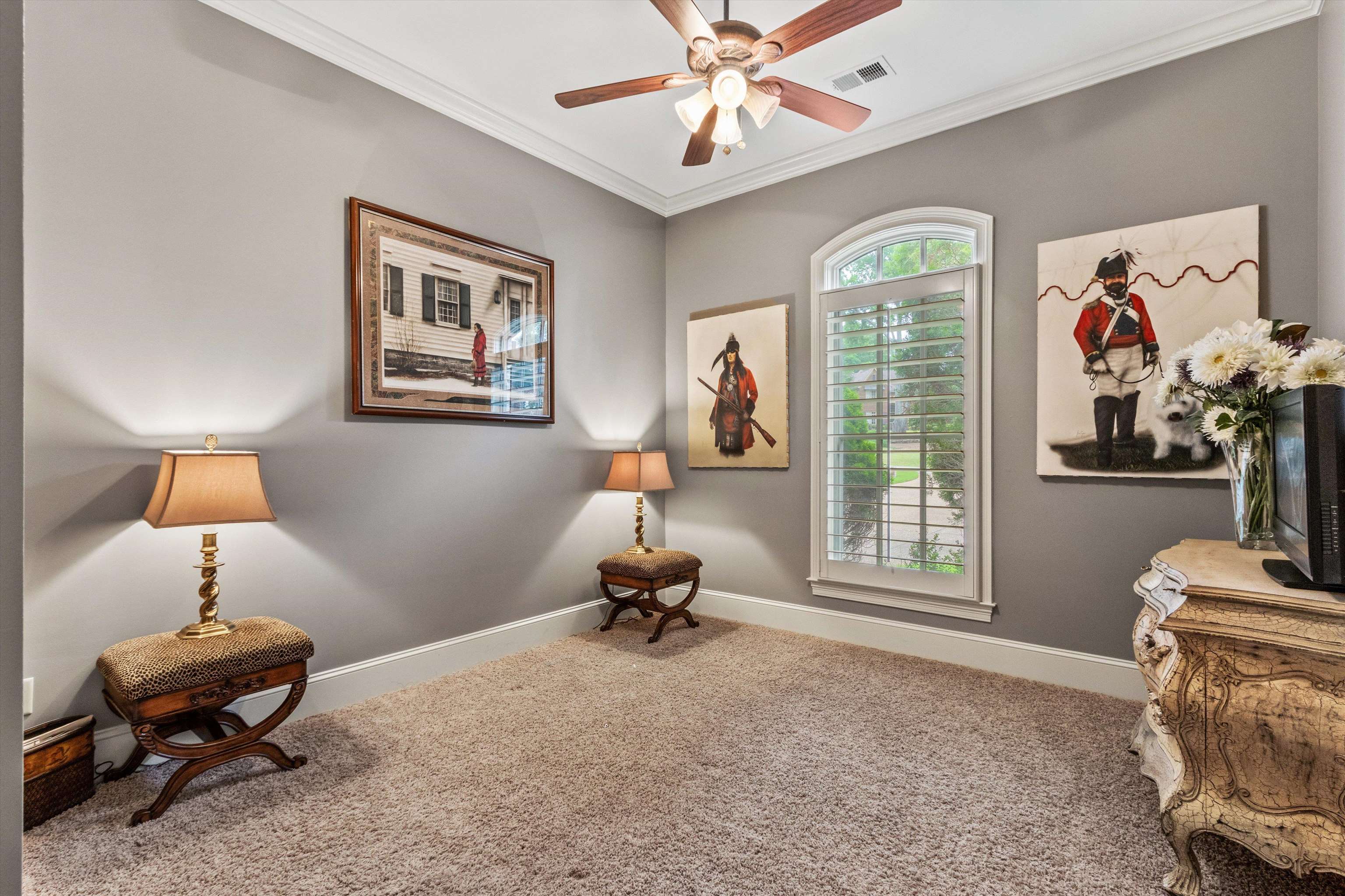 150 Ridgecrest Drive Arlington, TN 38002 - Photo 25 of 40 Arched window with plantation shutters, crown molding, a ceiling fan, and carpeted flooring