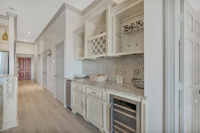 a kitchen with cabinets and wooden floor