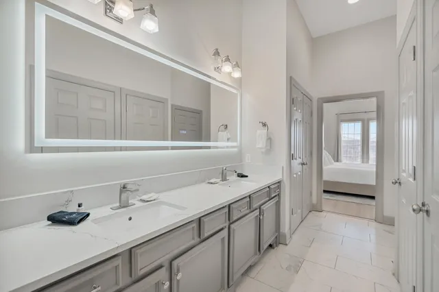 a bathroom with a sink double vanity and a mirror
