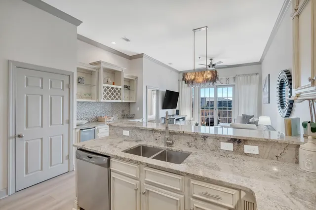a kitchen with stainless steel appliances granite countertop a sink a stove and a granite counter tops