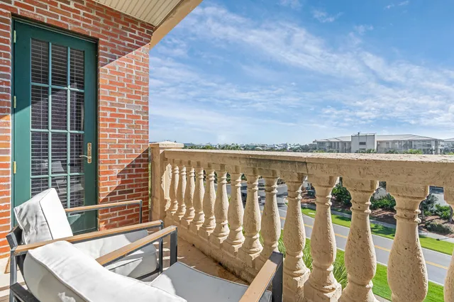 a roof deck with couches and wooden floor
