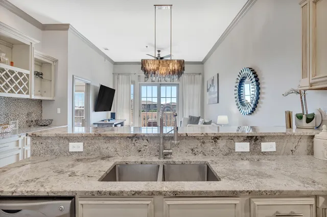 a kitchen with granite countertop a sink a counter and cabinets