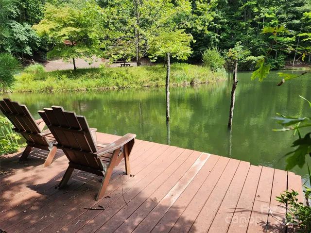 a wooden bench sitting next to a lake
