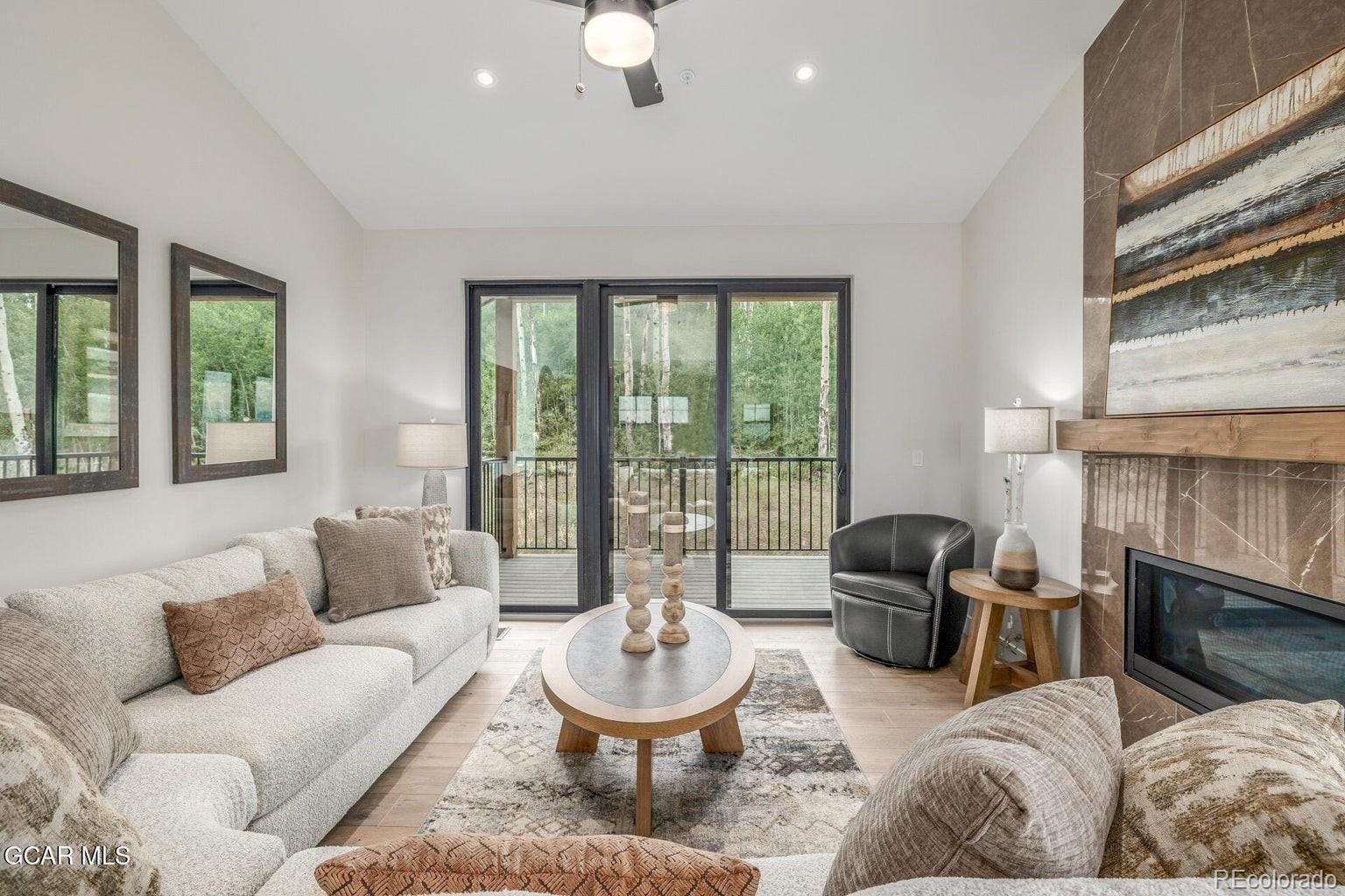 104 Saddle Mountain Camp Road Granby, CO 80446 - Photo 11 of 50 a living room with furniture and a large window