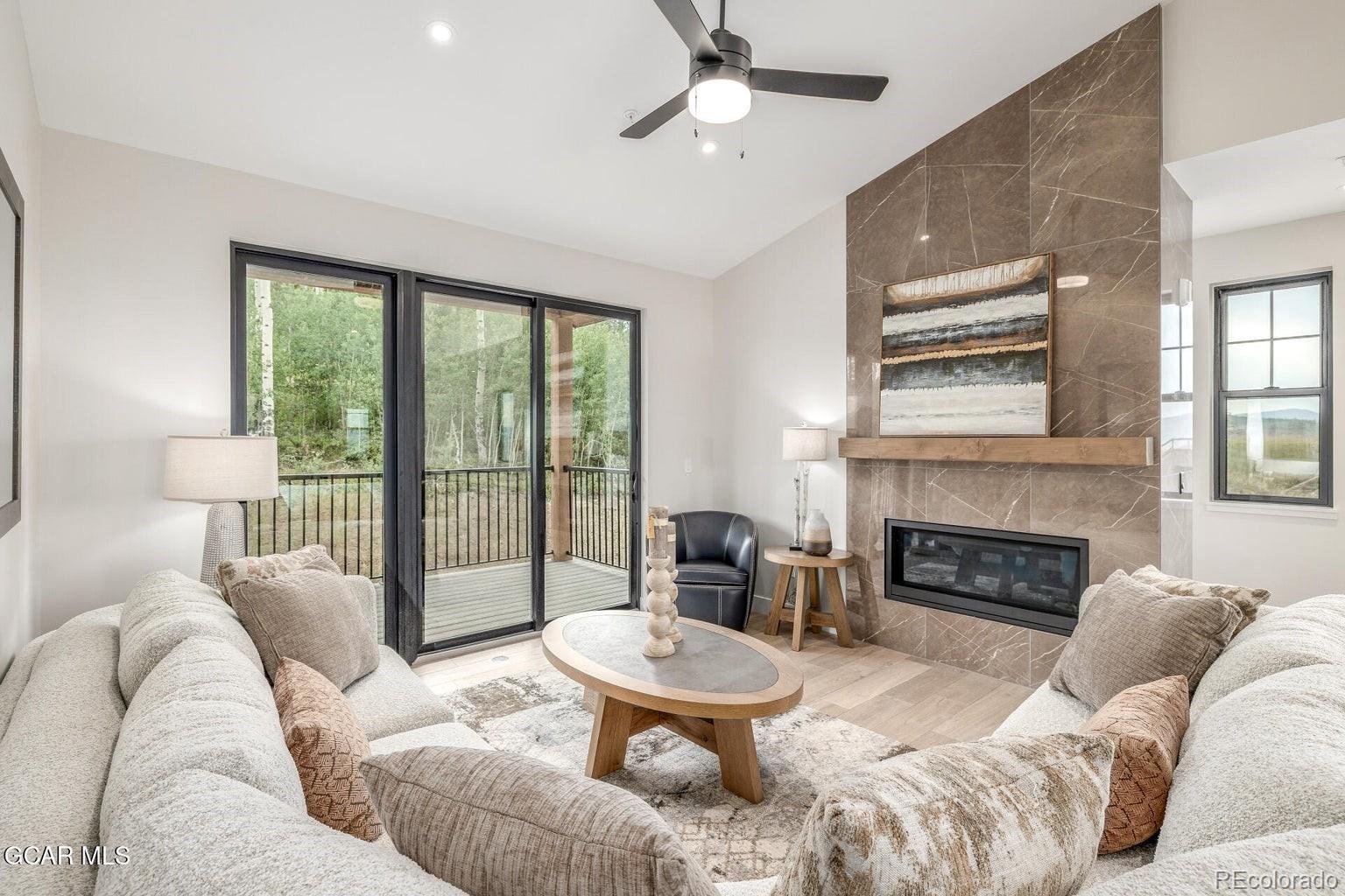 104 Saddle Mountain Camp Road Granby, CO 80446 - Photo 12 of 50 a living room with furniture and a fireplace
